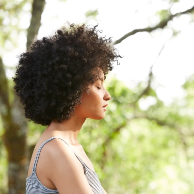 Meditation Retreats with IMCW, image of a woman meditating outside